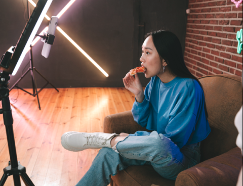 Woman eating in front of her webcam